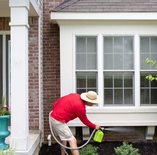 Man,Cleaning,The,Underside,Of,A,Bay,Or,Bump-out,Window
