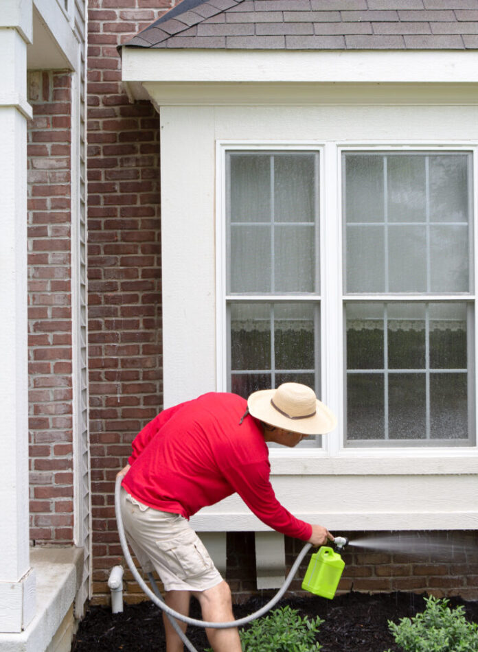 Man,Cleaning,The,Underside,Of,A,Bay,Or,Bump-out,Window